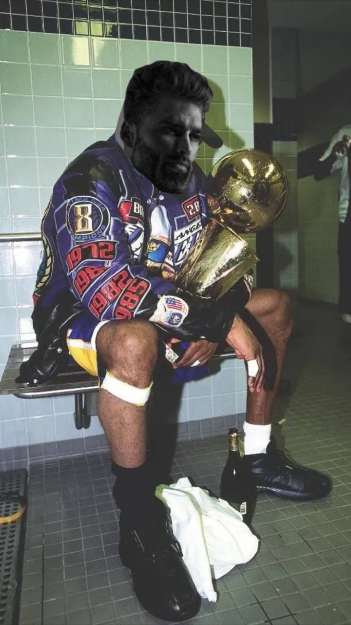 Muscular man celebrating with trophy in locker room.