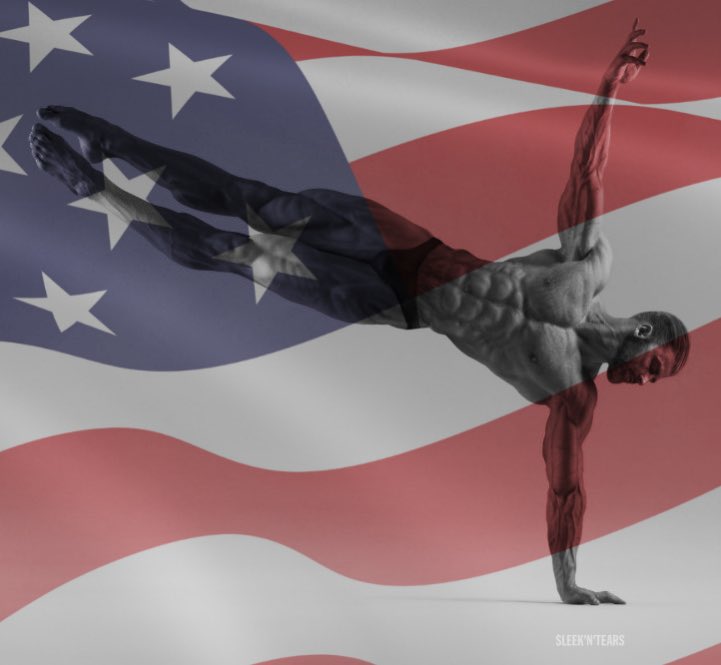 Muscular man doing a handstand against an American flag background.