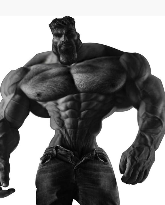 Muscle-bound man in jeans exudes confidence and strength.
